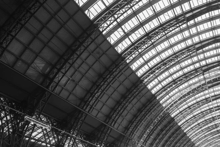 Close-up of a large curved steel truss roof structure